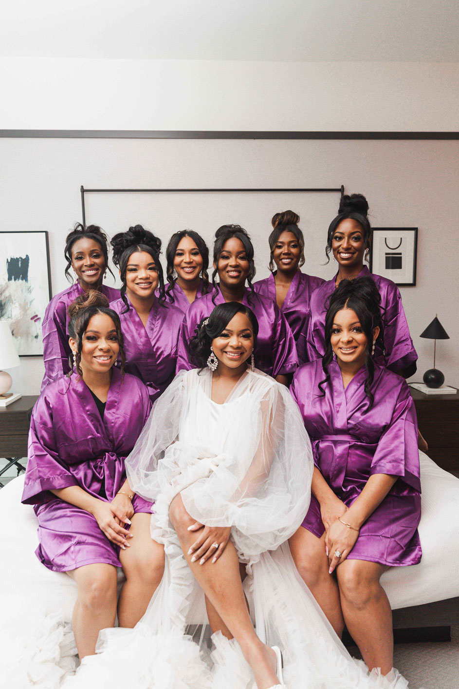 The bridesmaids pose with bride while getting ready on the day of her Birmingham wedding.