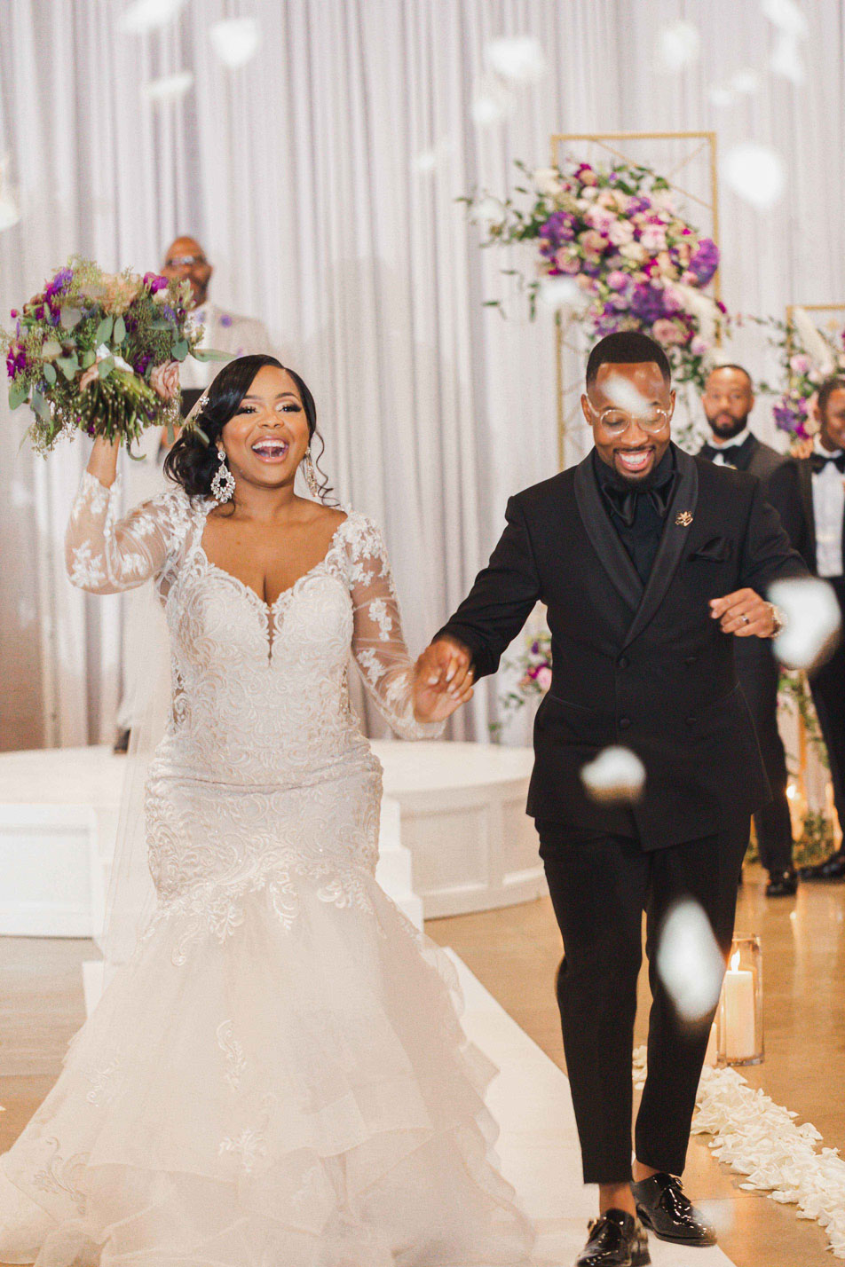 The bride and groom exit the wedding ceremony at Haven in downtown Birmingham.