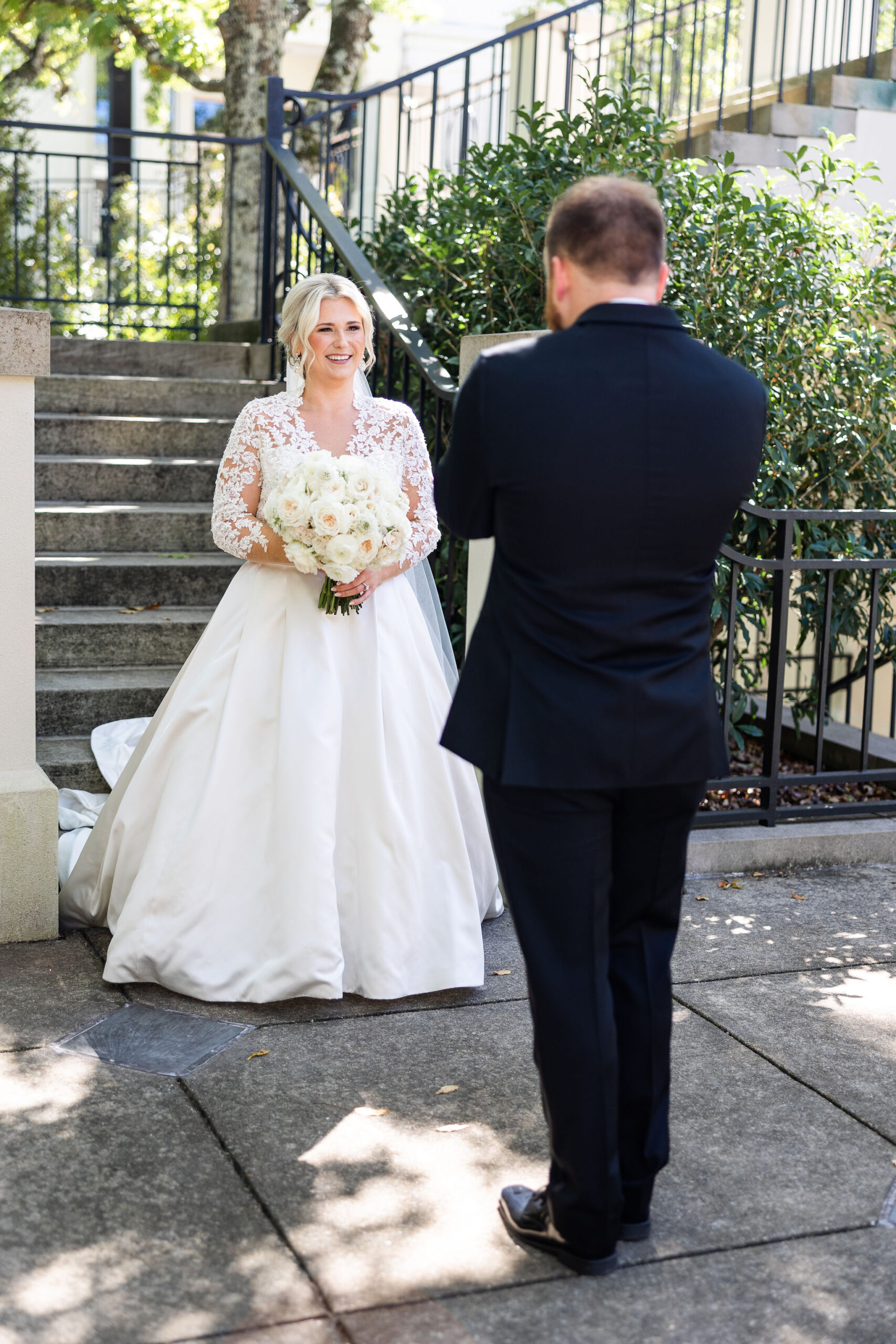 The bride approaches the groom for a first look before their Southern wedding.