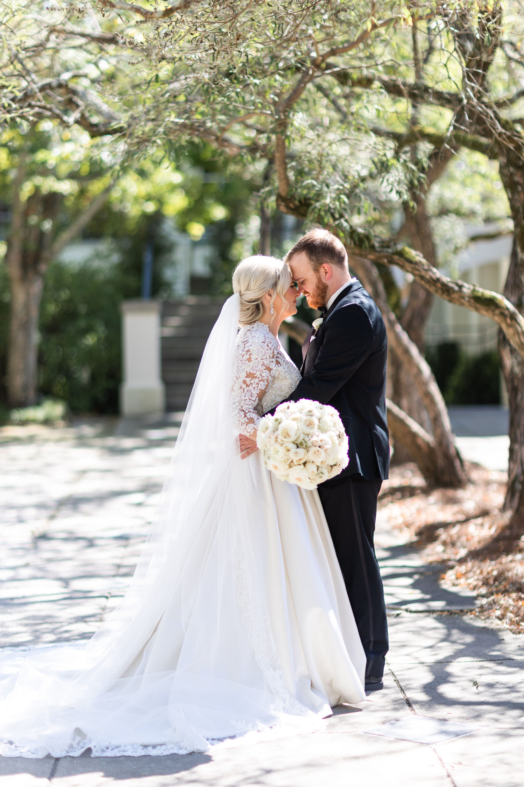 The bride and groom embrace at Birmingham Botanical Gardens.