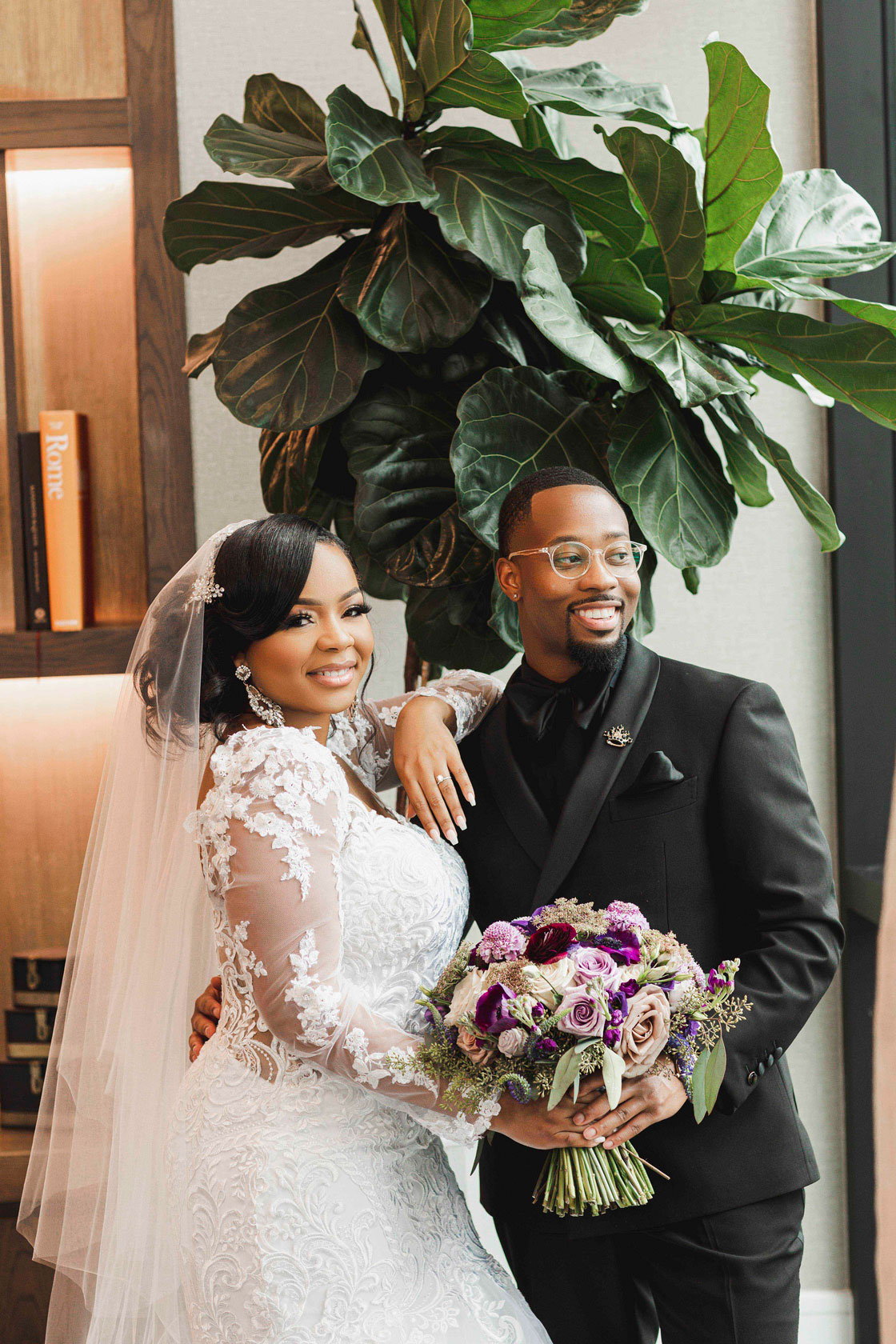 The bride and groom hold the purple bouquet together at The Valley Hotel.