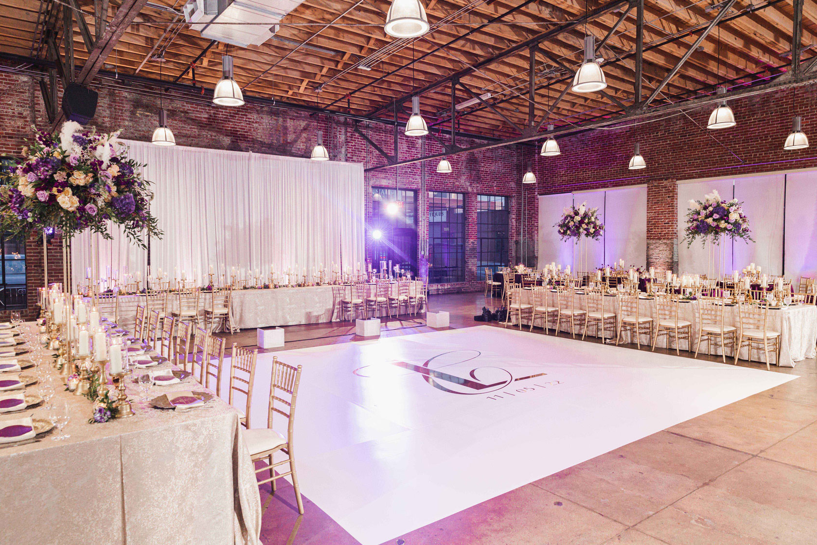 The custom dance floor is in the middle of the wedding reception hall at Haven in Birmingham, Alabama.