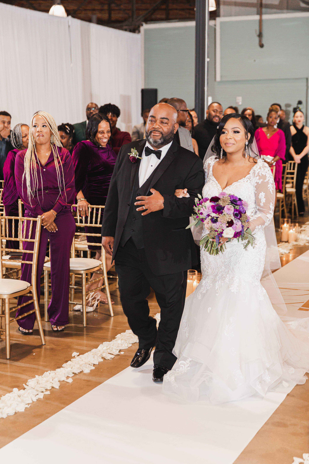 The father of the bride walks his daughter down the aisle during the wedding ceremony at Haven in Birmingham.