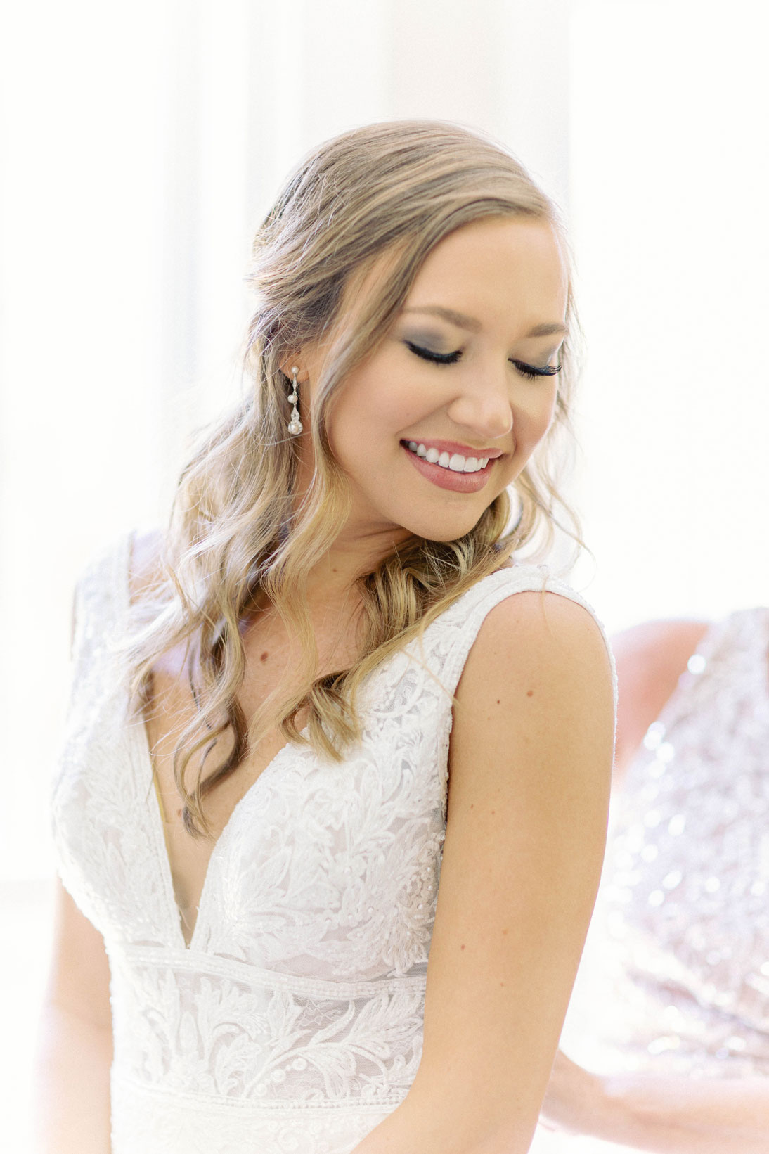 The bride puts on her wedding dress.