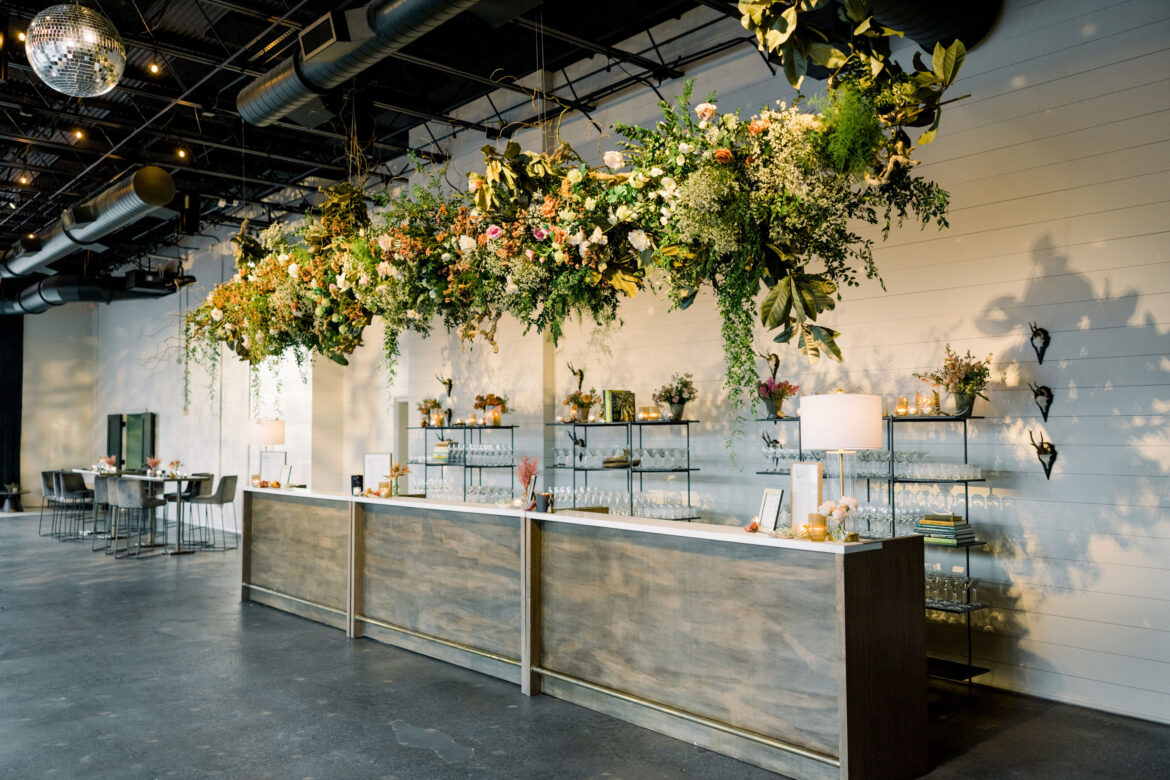 The bar at the Alabama Weddings party in Birmingham features a large floral installation.