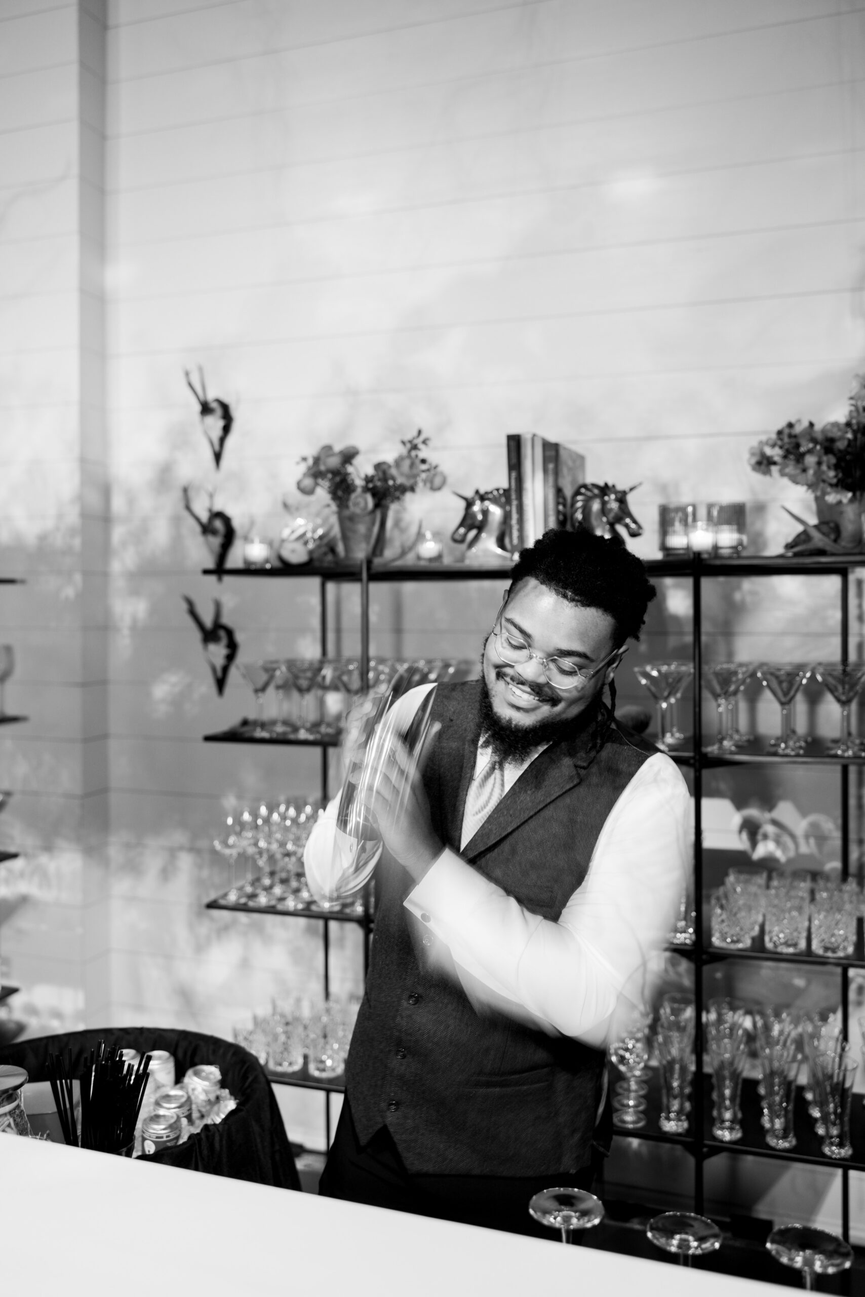 The bartender shakes a cocktail at the Alabama Weddings party.