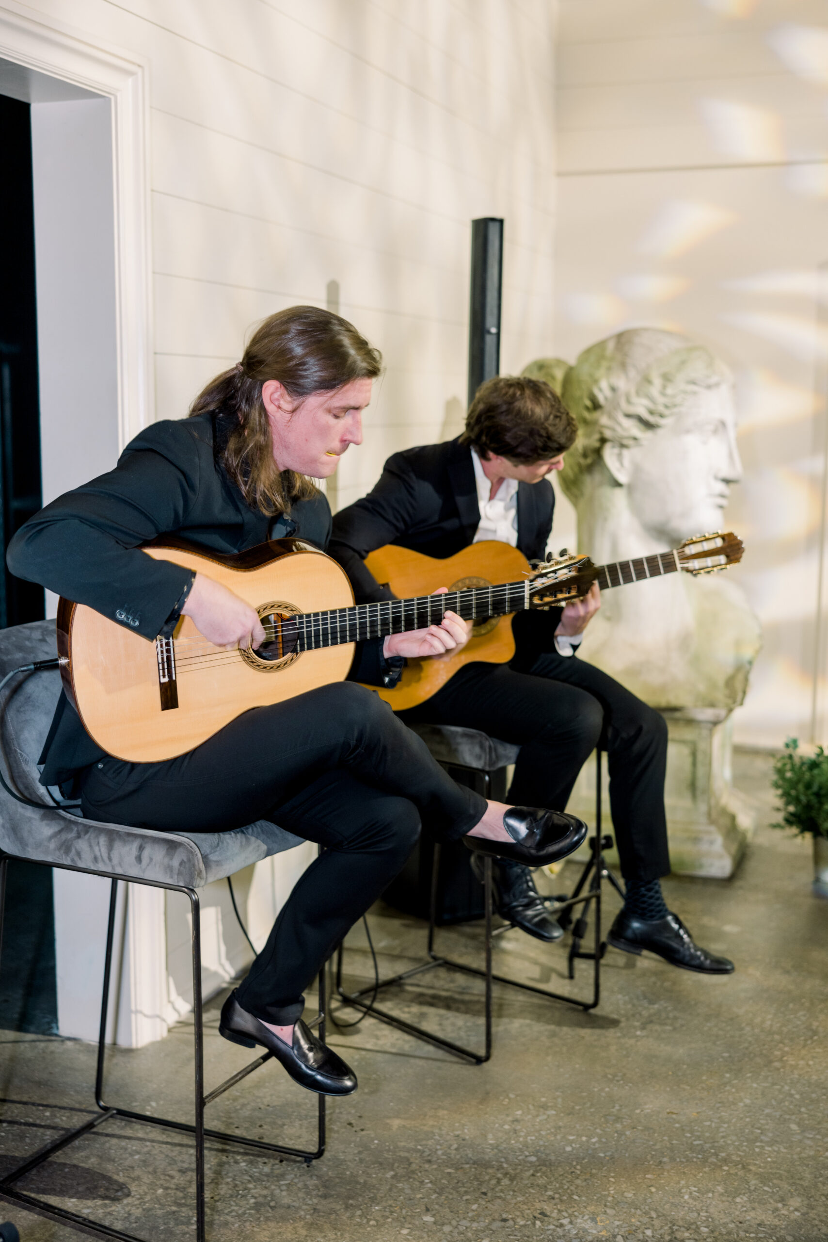 Roman Street Band plays the guitar as guests arrive at the Alabama Weddings party.