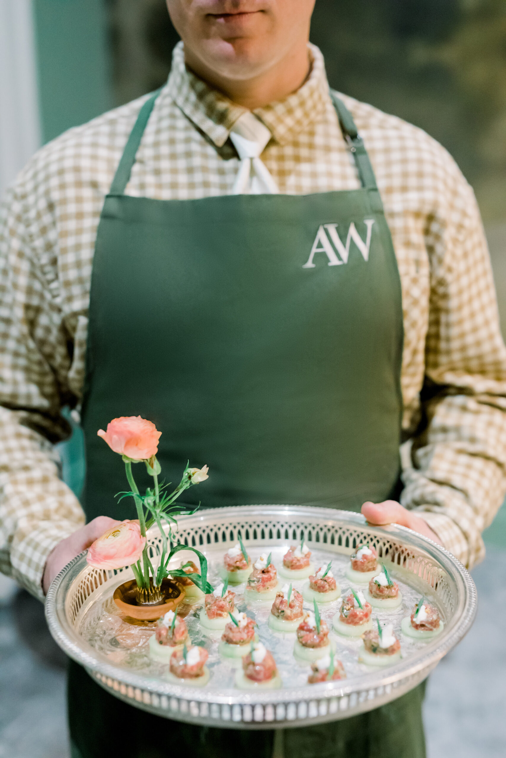 Hastings Catering presents passed appetizers while wearing custom monogrammed aprons at the Alabama Weddings party.