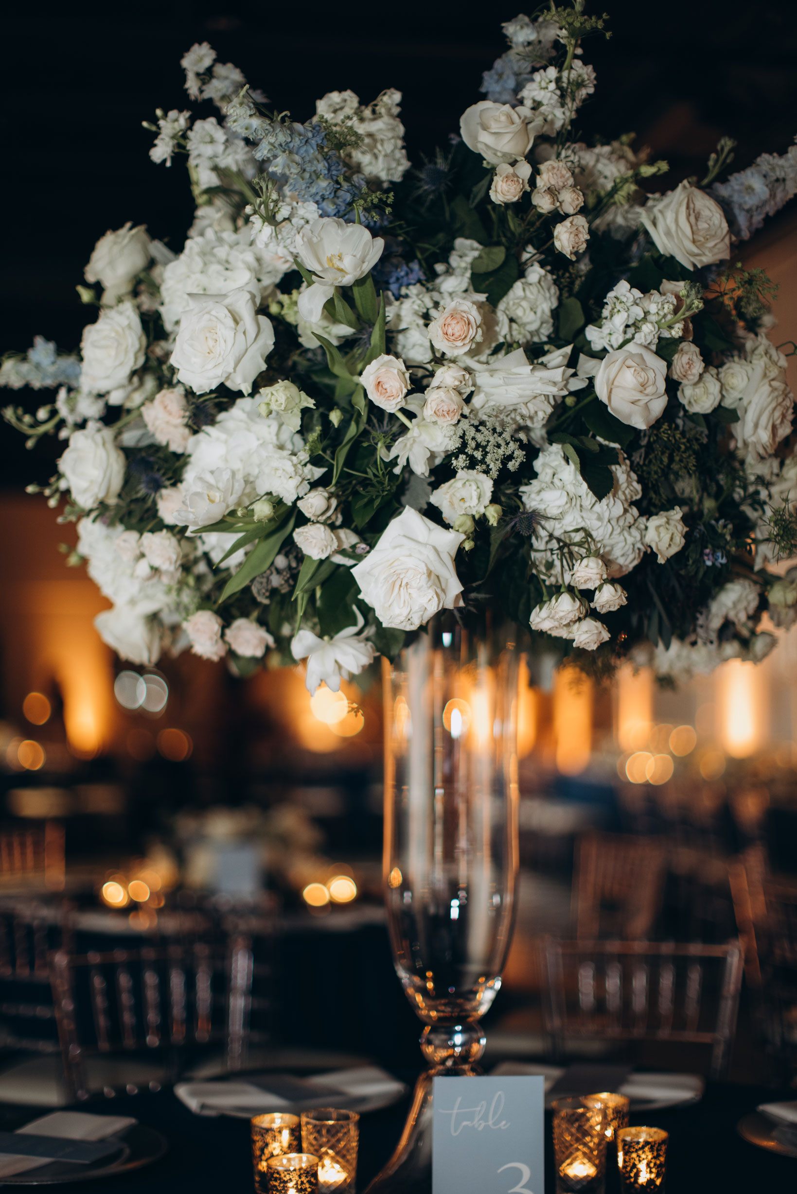 The reception centerpiece for this wedding at The Farrell features white and blue flowers.