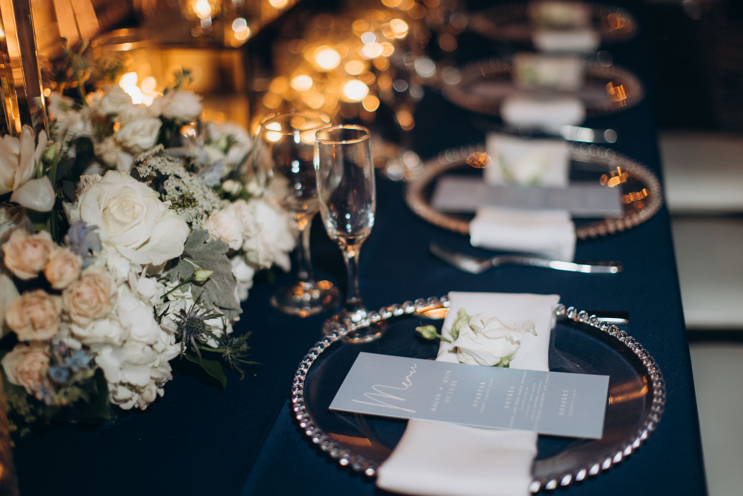 Menus are placed on chargers for the wedding reception at The Farrell in Homewood, Alabama.