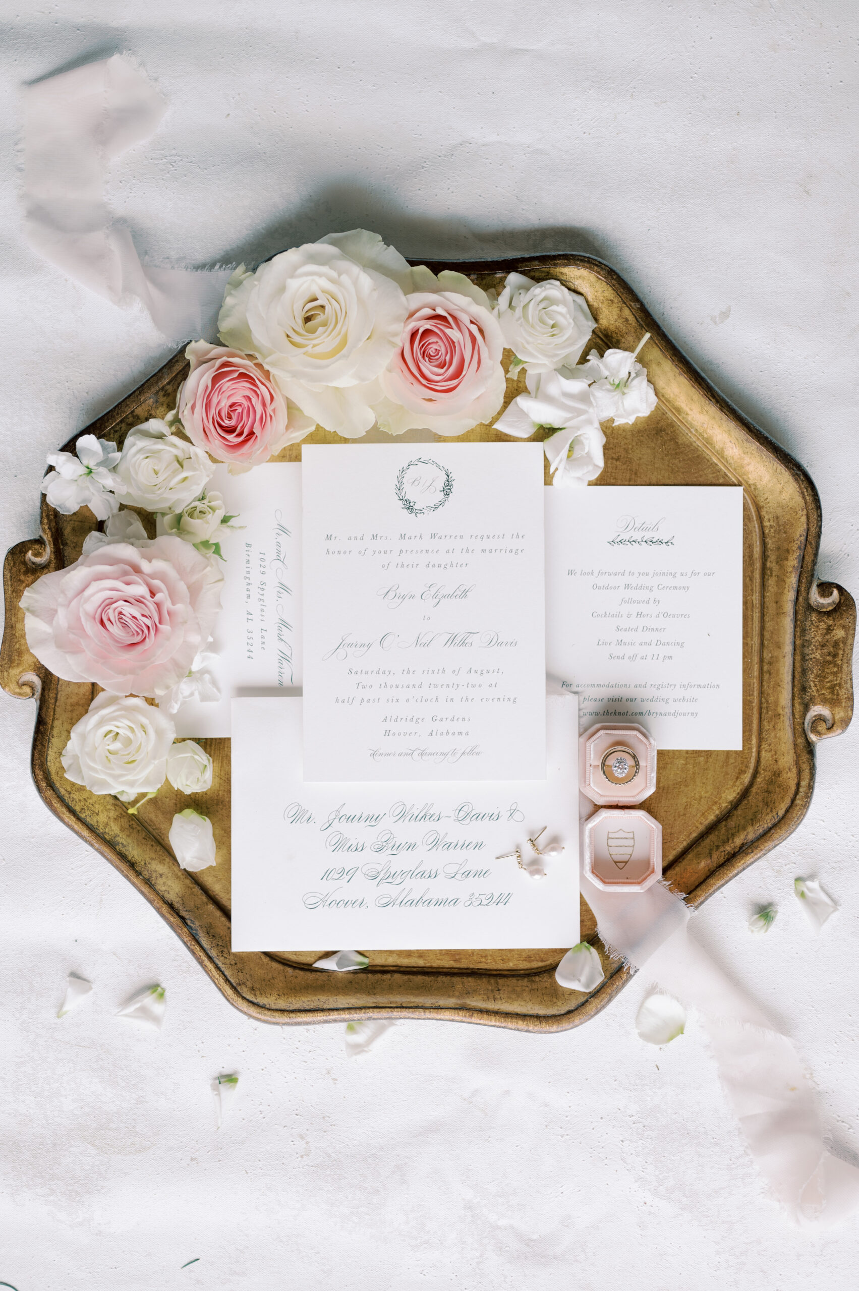 The Southern wedding invitations are photographed on a golden tray.