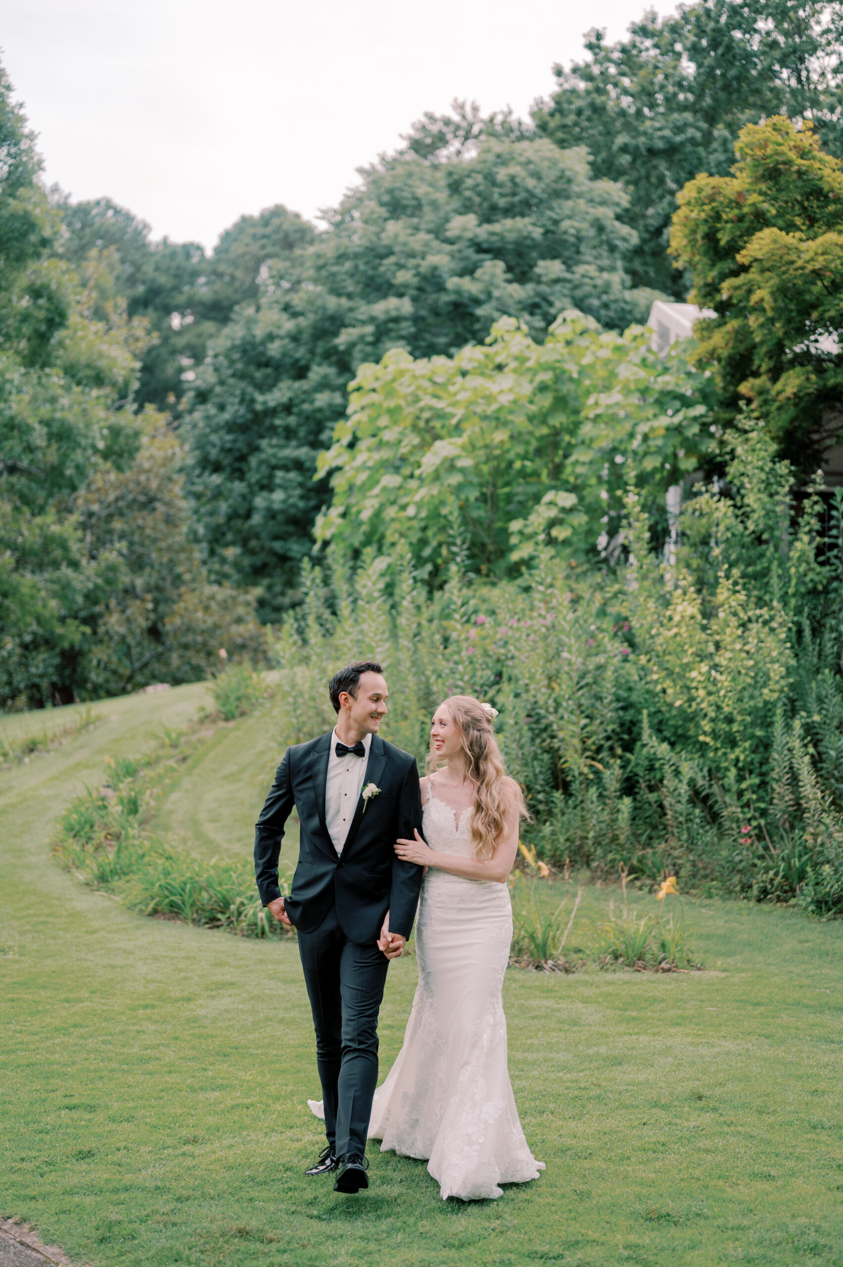 The bride and groom walk together at Aldridge Garden.