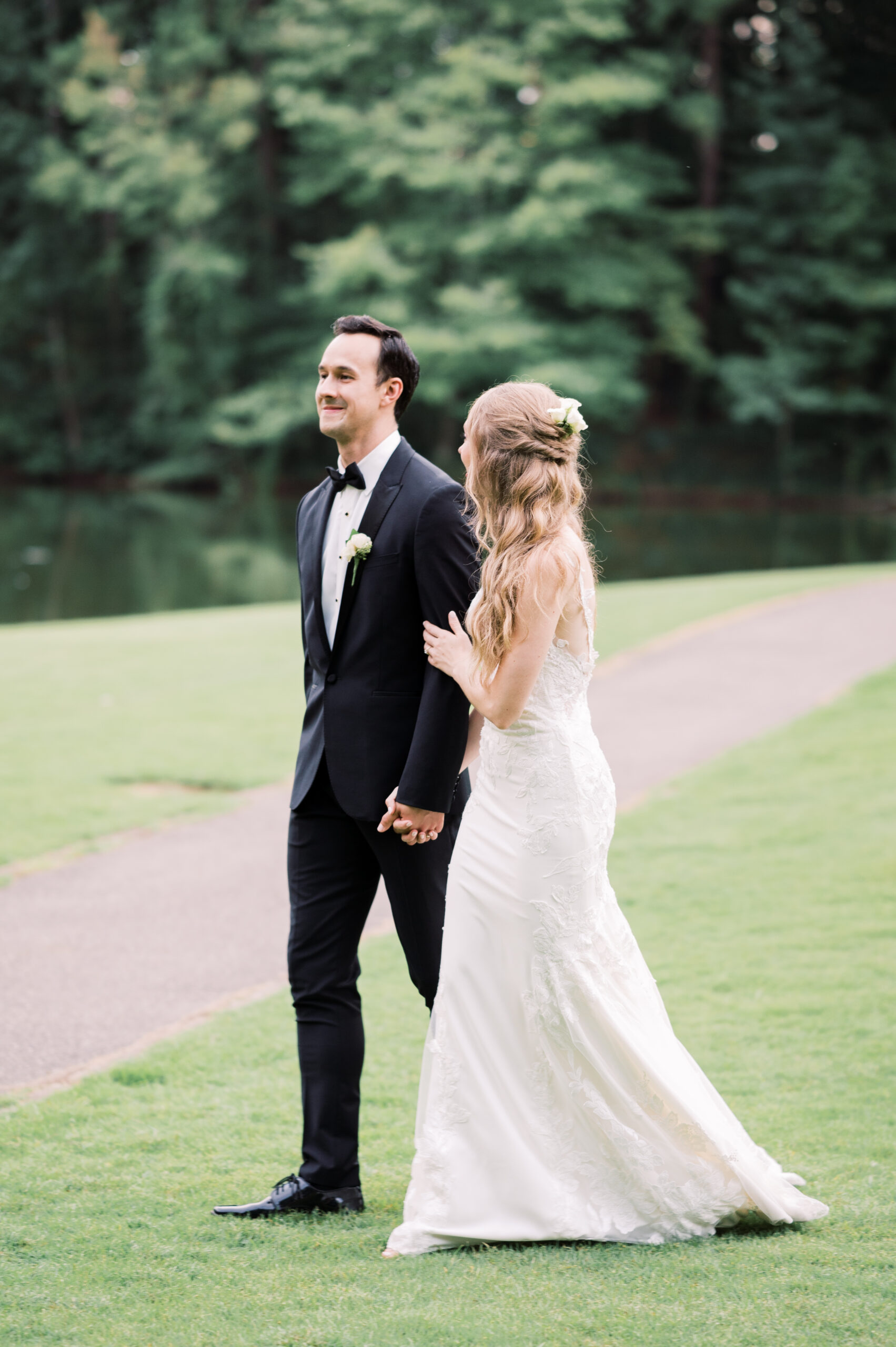 The bride and groom walk together to their reception at Aldridge Garden.