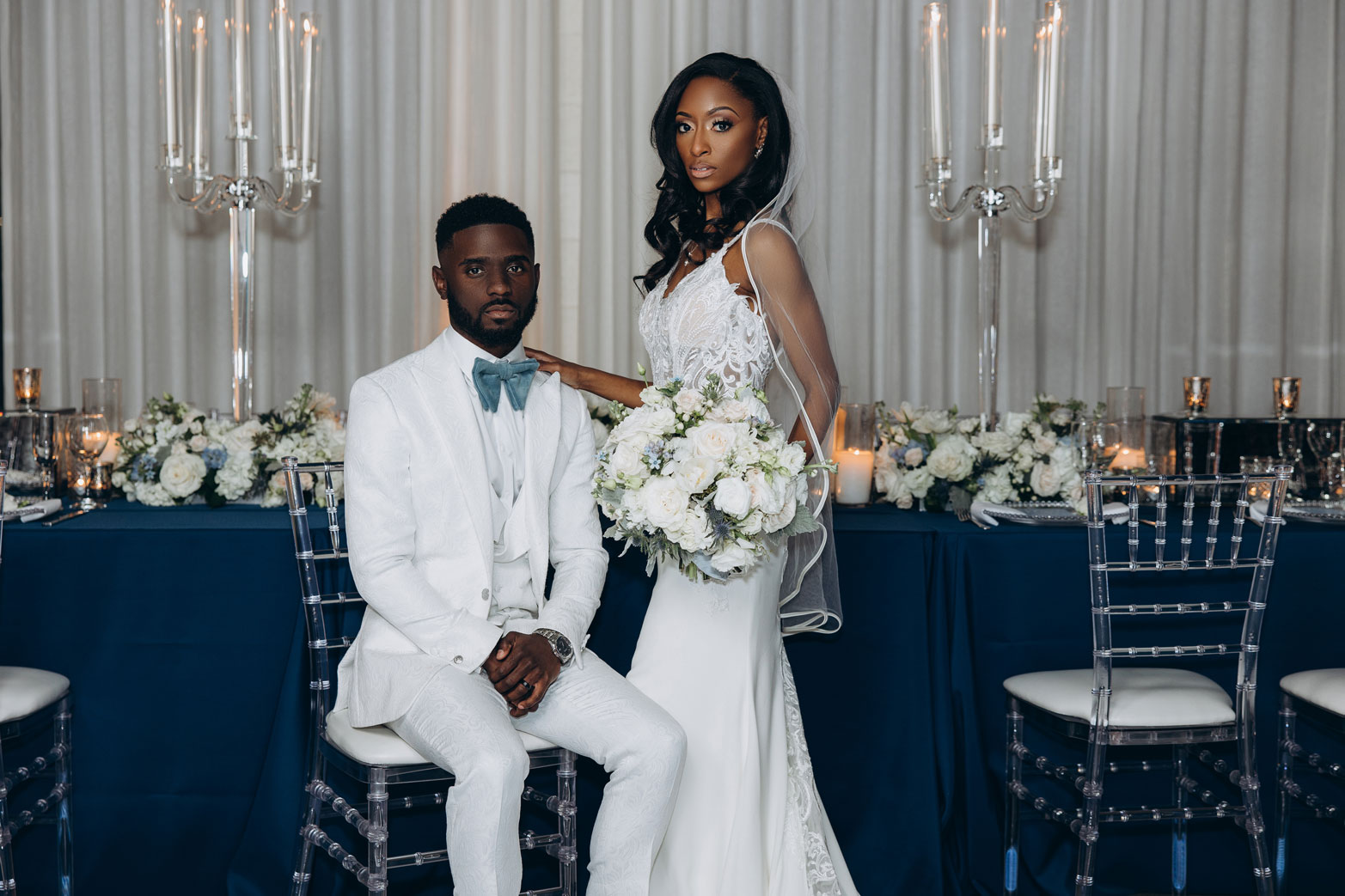 The bride and groom stand in front of the head table at the reception at The Farrell in Alabama.