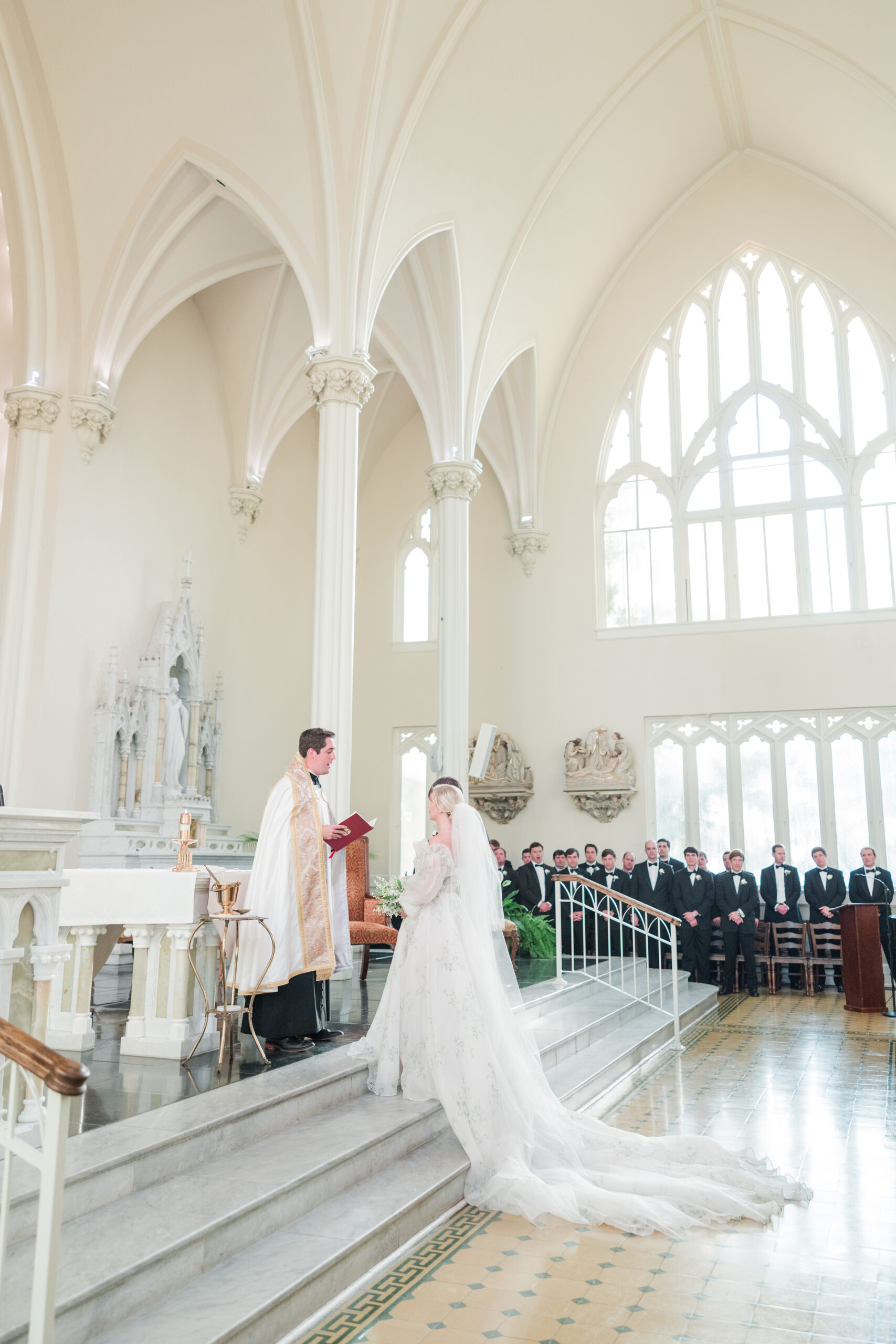 The bride and groom recite their vows during the wedding ceremony in Mobile, Alabama.