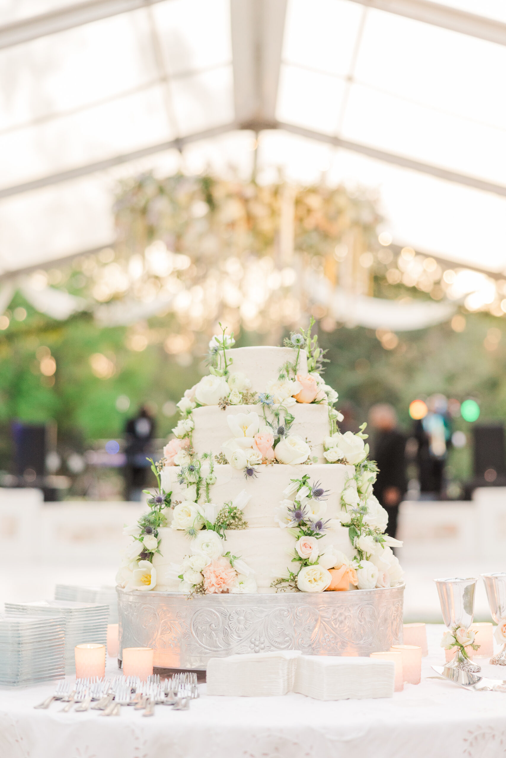 The spring wedding cake is decorated with fresh flowers for this reception in Mobile, Alabama.