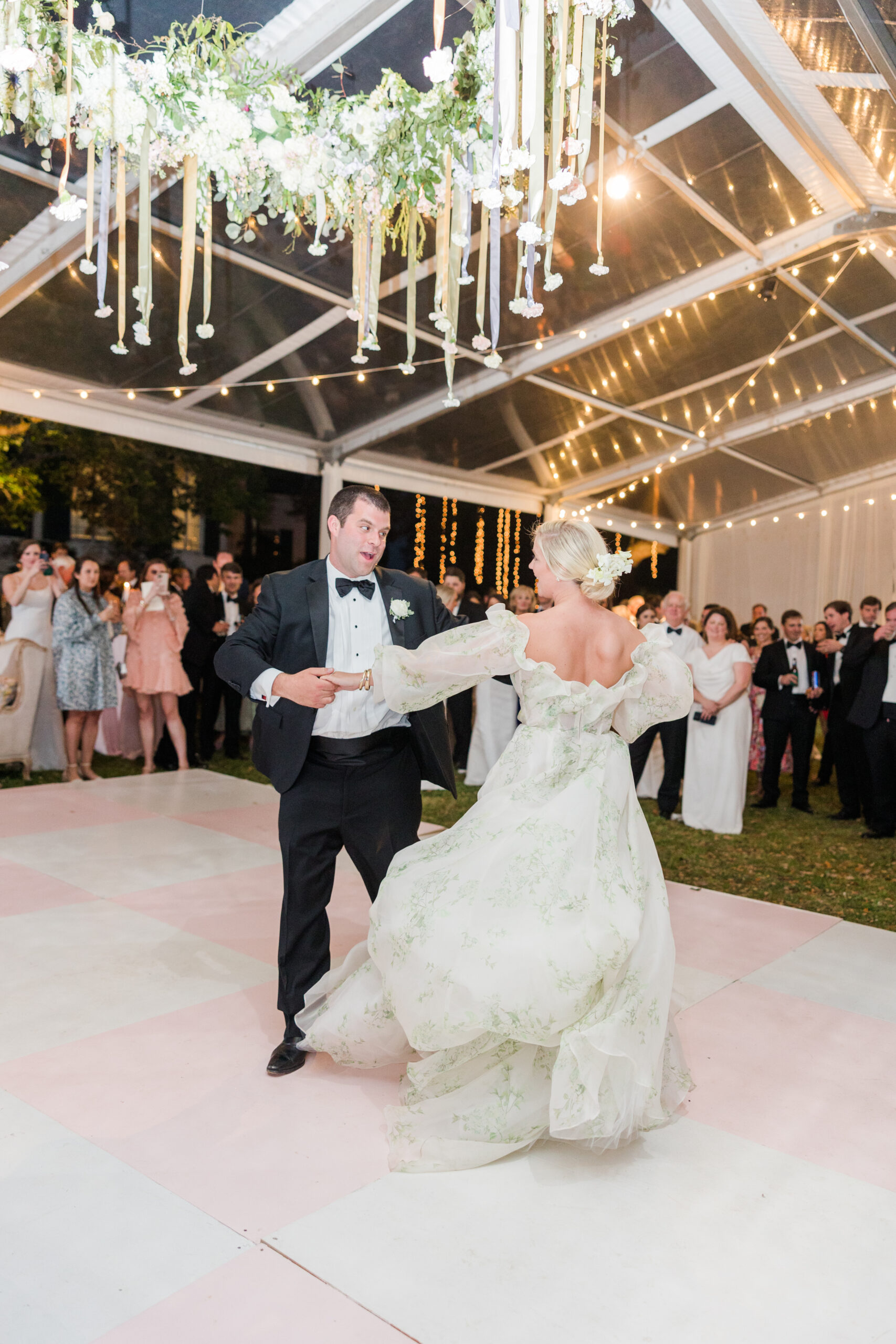 The bride and groom share their first dance during their spring wedding reception in Mobile, Alabama.