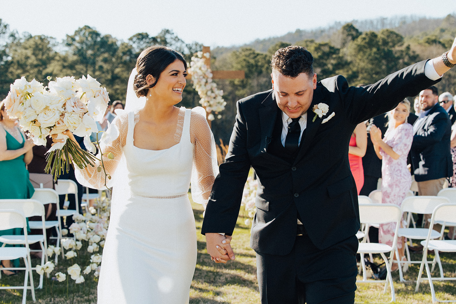 The groom and bride walk back down the aisle from their Alabama wedding ceremony.