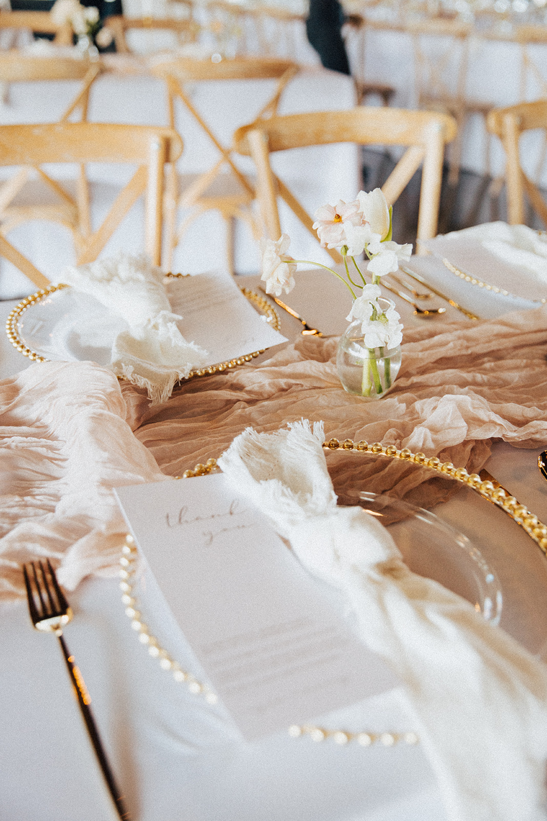 The table is set with a custom silk runner for the wedding reception at Ridge Pointe.