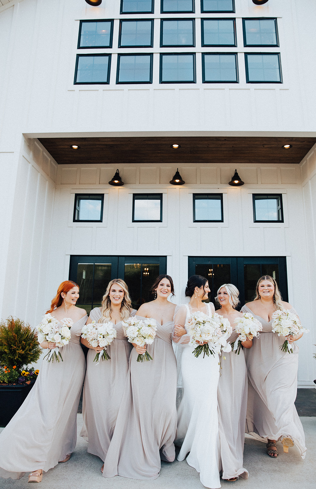 The bride walks with her bridesmaids outside Ridge Pointe event venue in North Alabama.