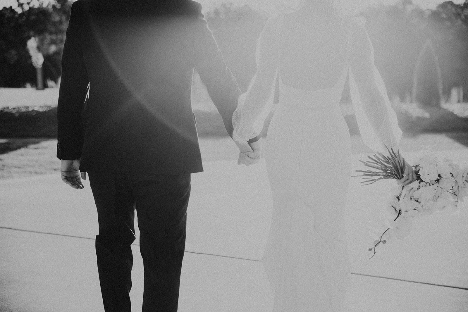 The bride and groom walk hand in hand before the wedding in North Alabama.