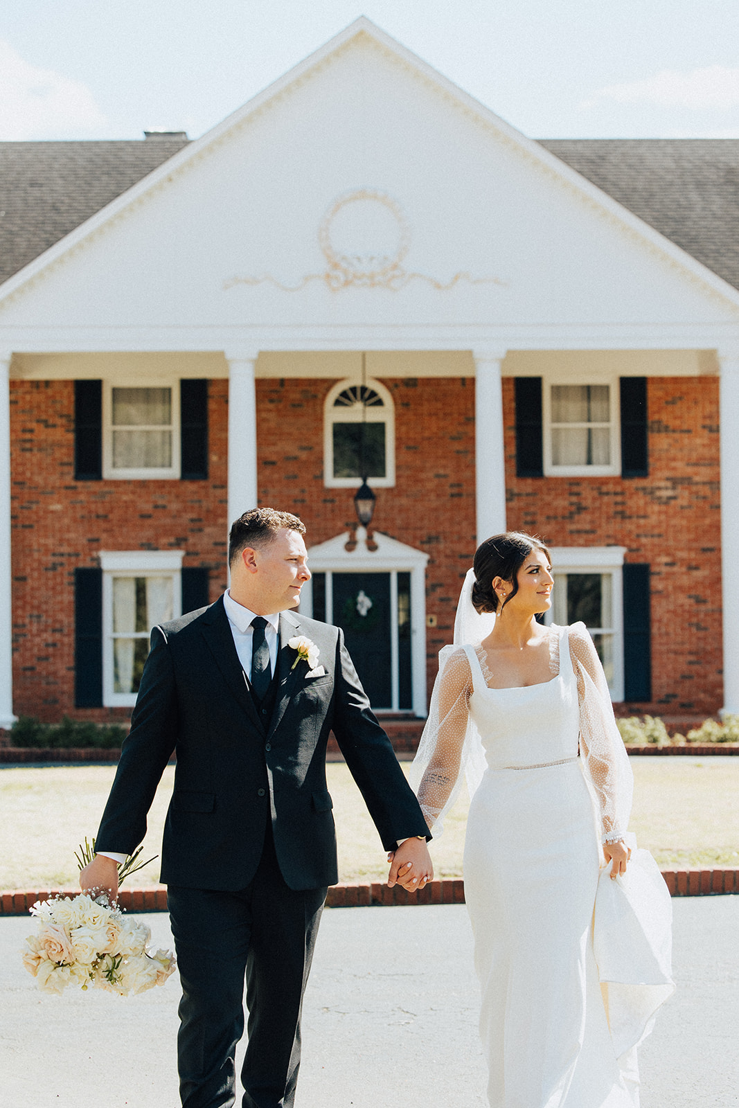 The bride and groom walk together on a sunny day in North Alabama.