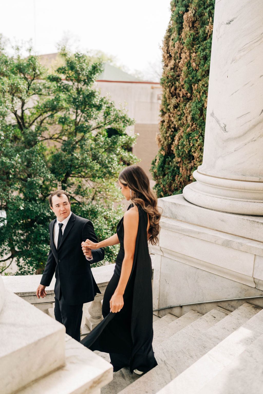 The man walks his fiancee down the stairs in downtown Birmingham, Alabama.