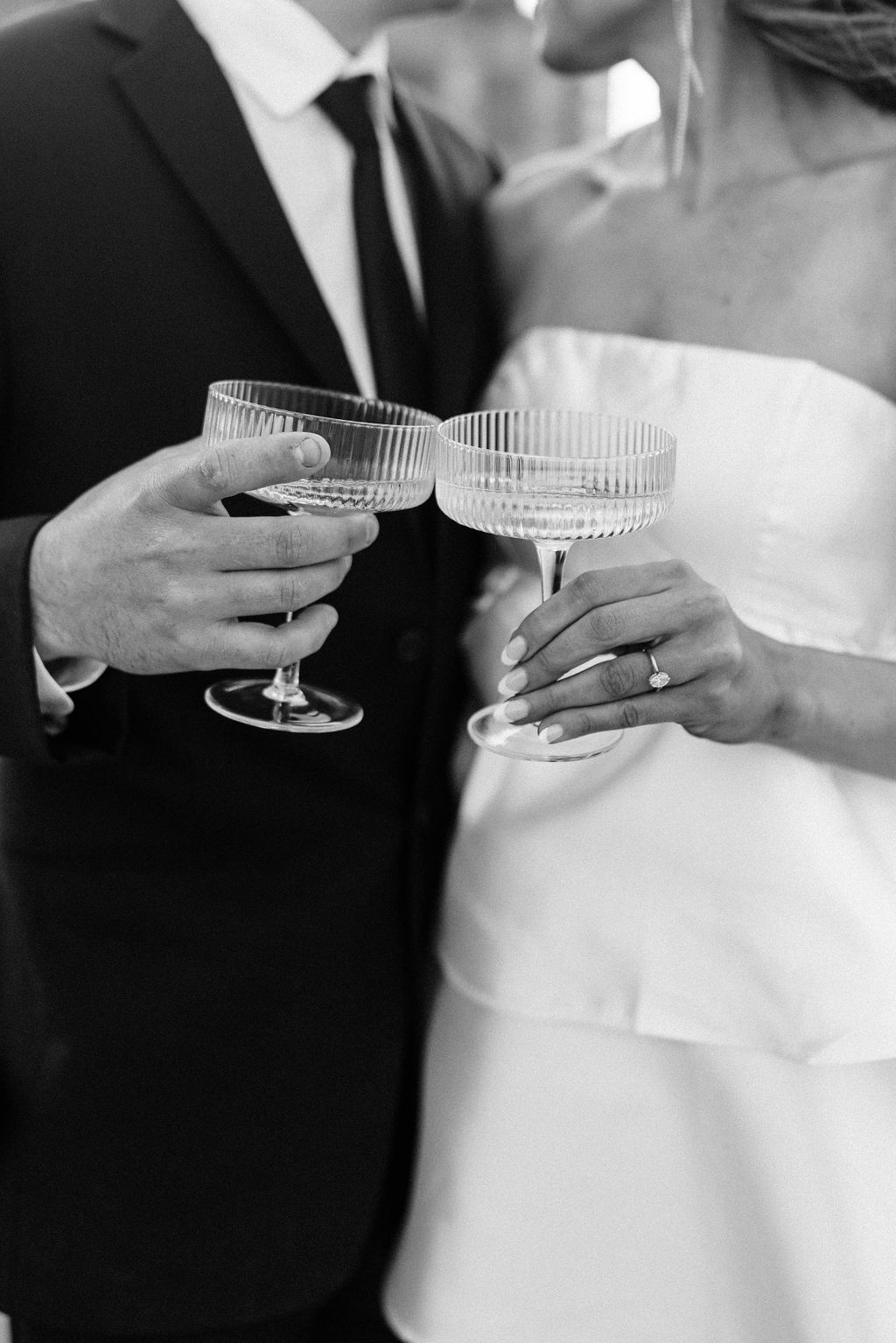 The bride and groom hold champagne coups to celebrate the engagement in Bimingham, Alabama.