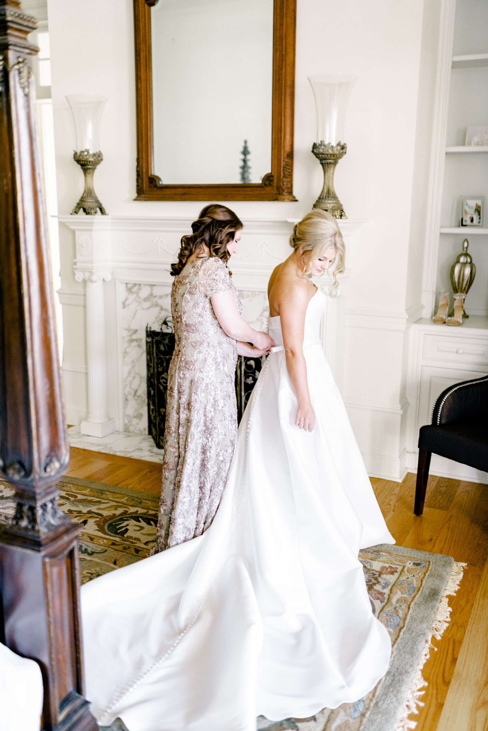 The bride puts on her wedding dress at Marsgate wedding venue.