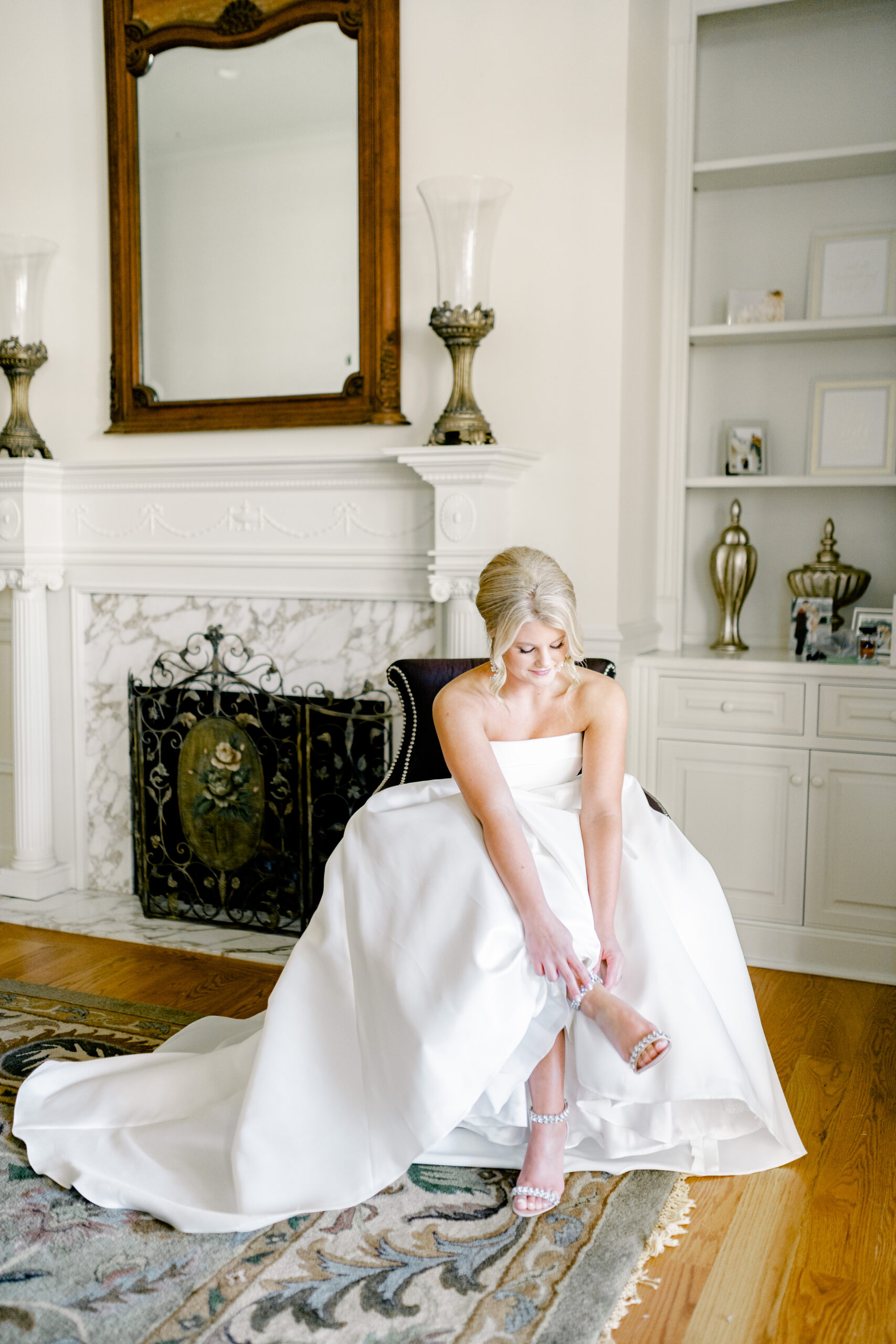 The bride puts on her shoes before her spring wedding ceremony at Marsgate.