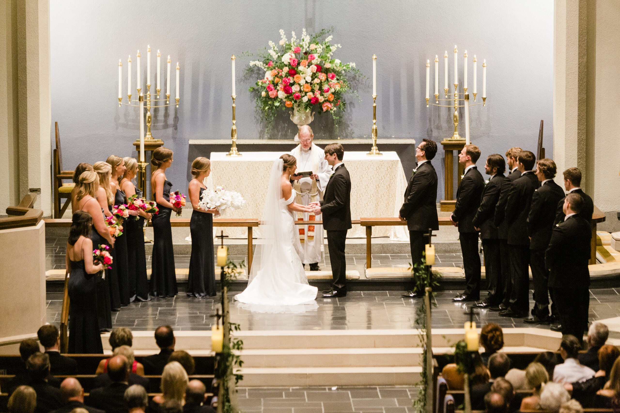 The bride and groom share their vows at the church altar.