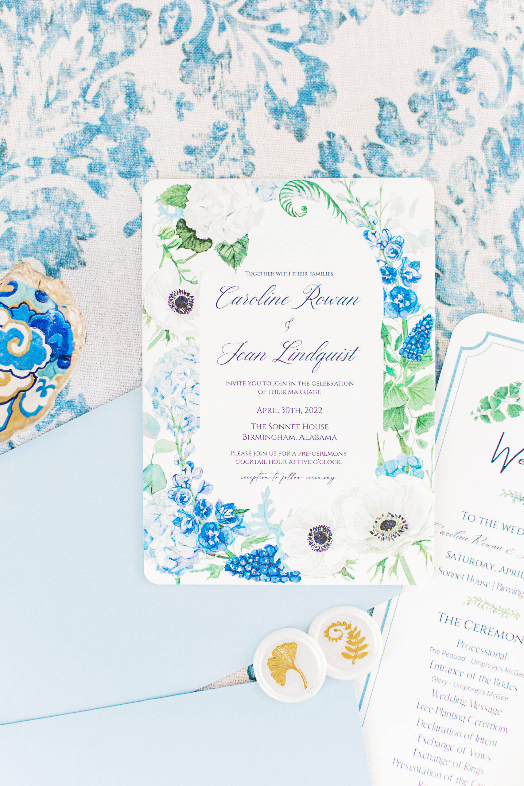 The wedding invitations are photographed in a lay flat style for the Southern wedding.