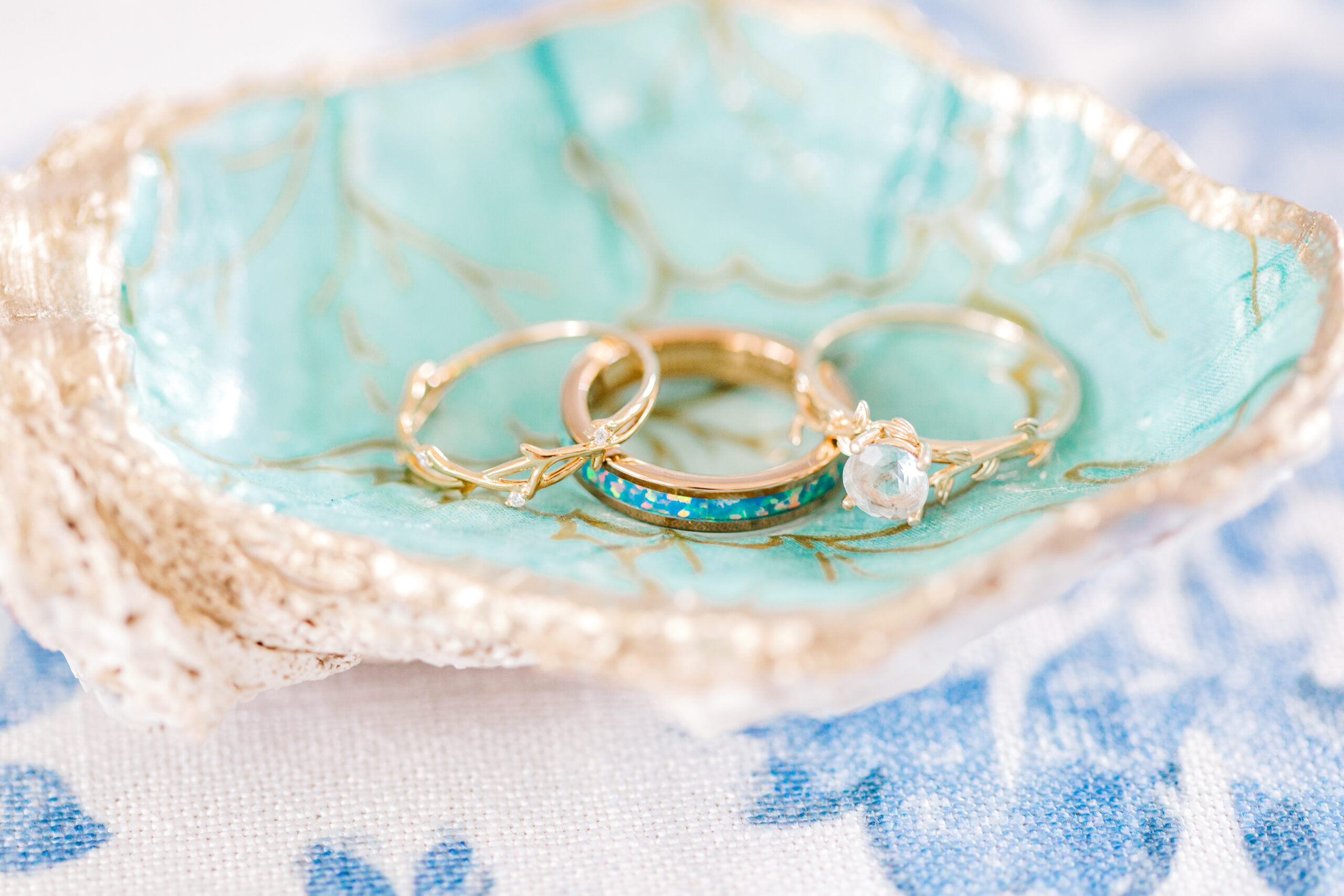 The wedding rings are photographed in a dish for the Southern wedding.