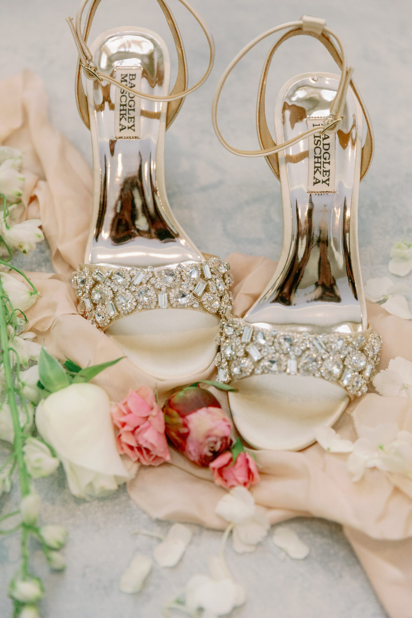 The Badgley Mischka shoes are photographed with flowers by Carla Lawrence Photography.