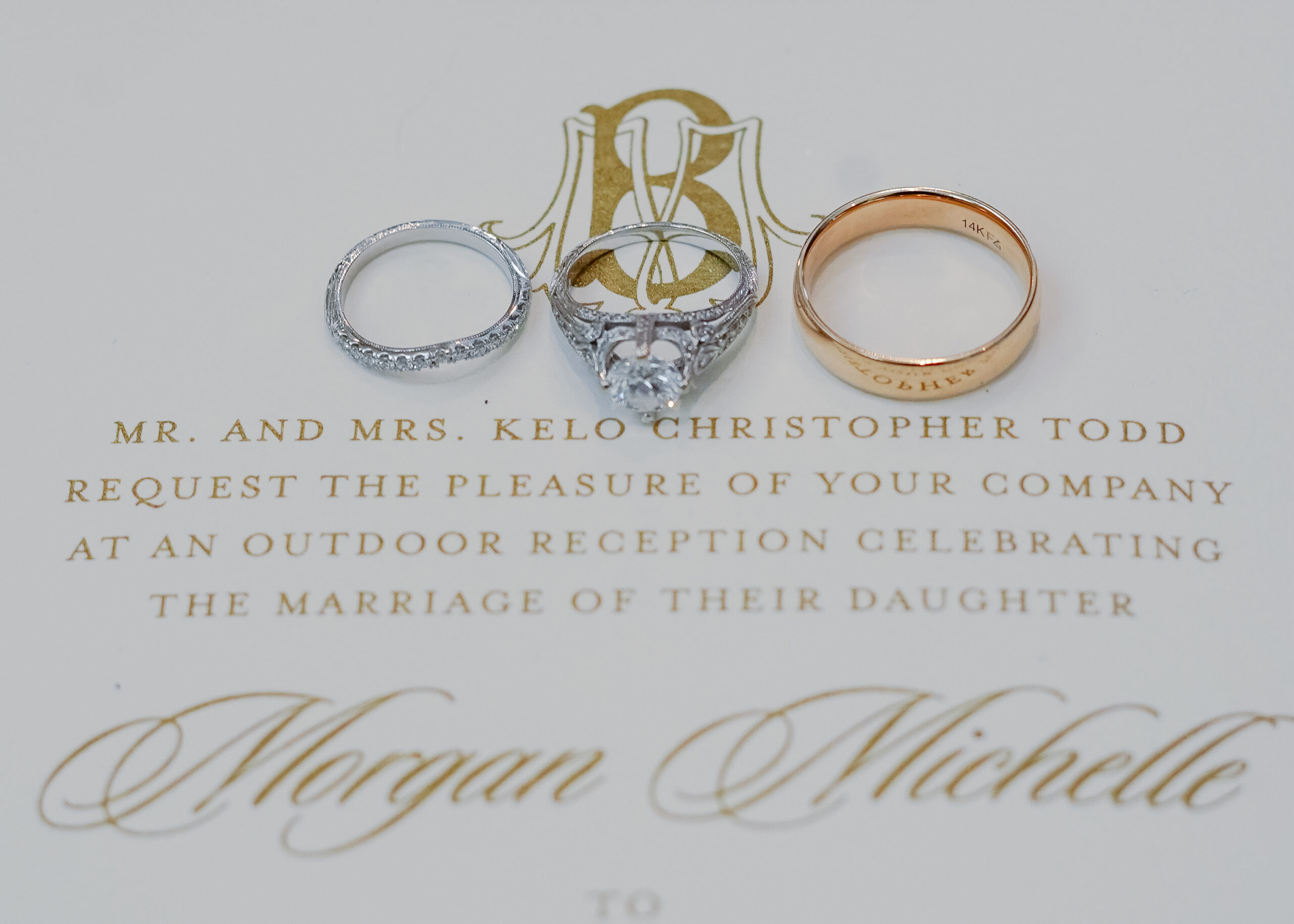 The wedding rings are photographed on the Southern wedding invitations.