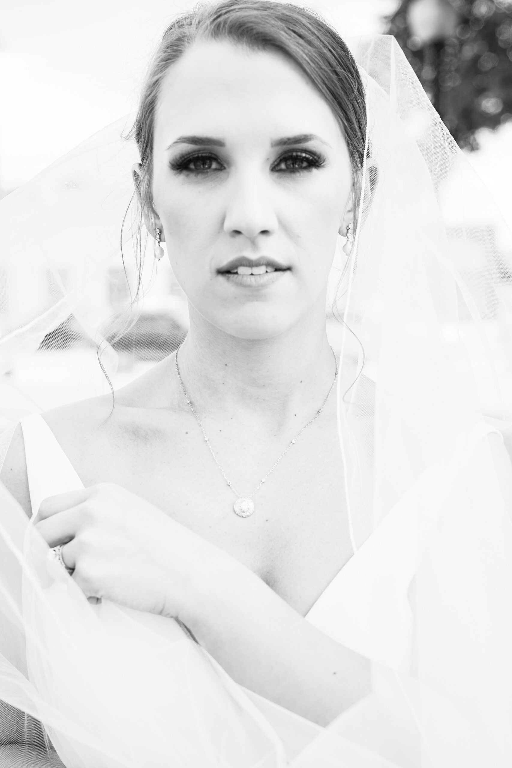 The bride is photographed in black and white by Carla Lawrence Photography.