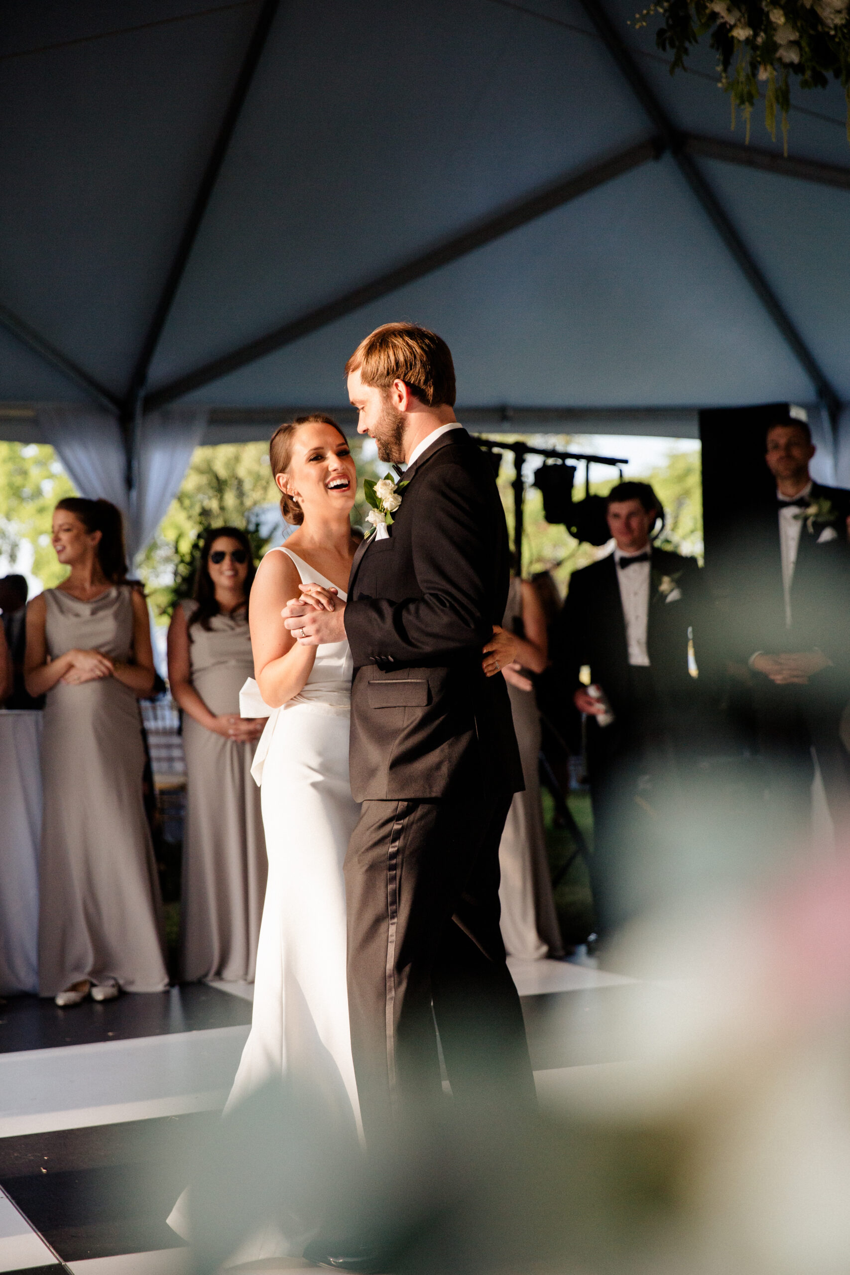 The bride and groom share a first dance under the reception tent.