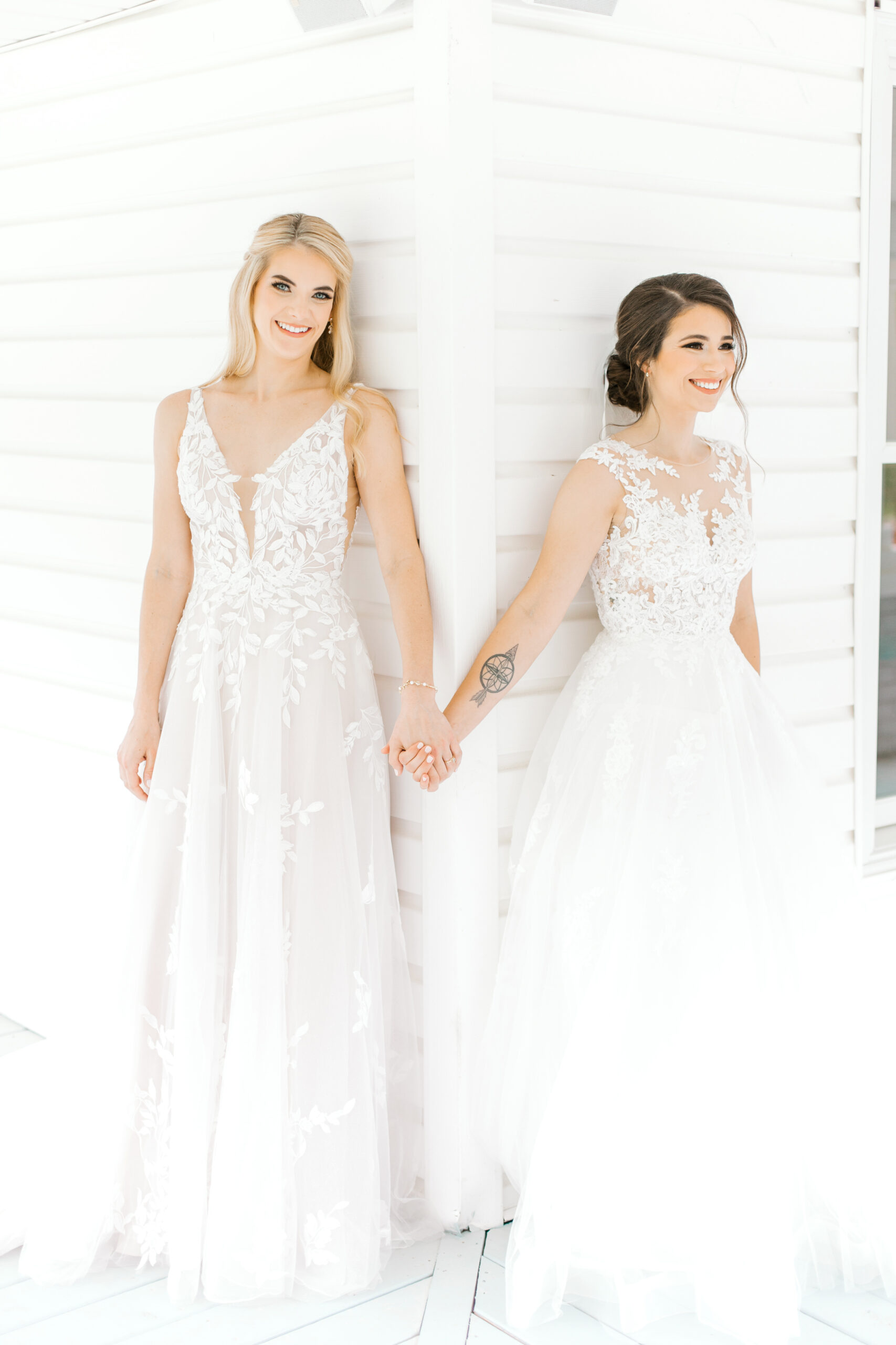 The brides hold hands before the Southern wedding ceremony at The Sonnet House.