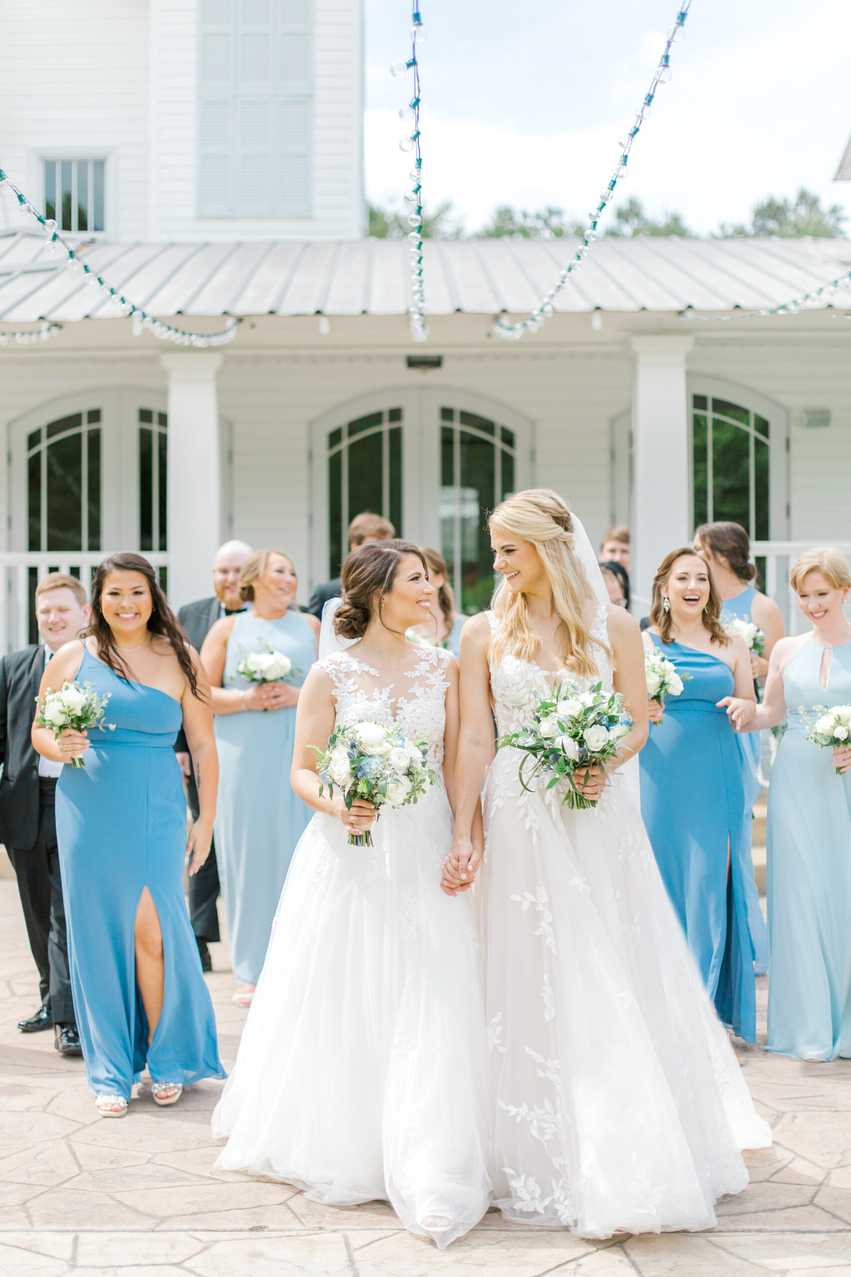 The brides walk together with the wedding party at The Sonnet House.