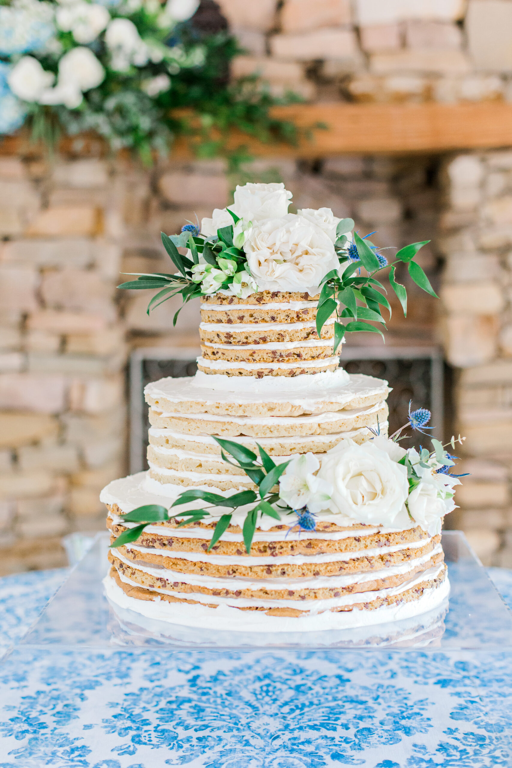 The naked cake by Magic Muffins is decorated with flowers at The Sonnet House.