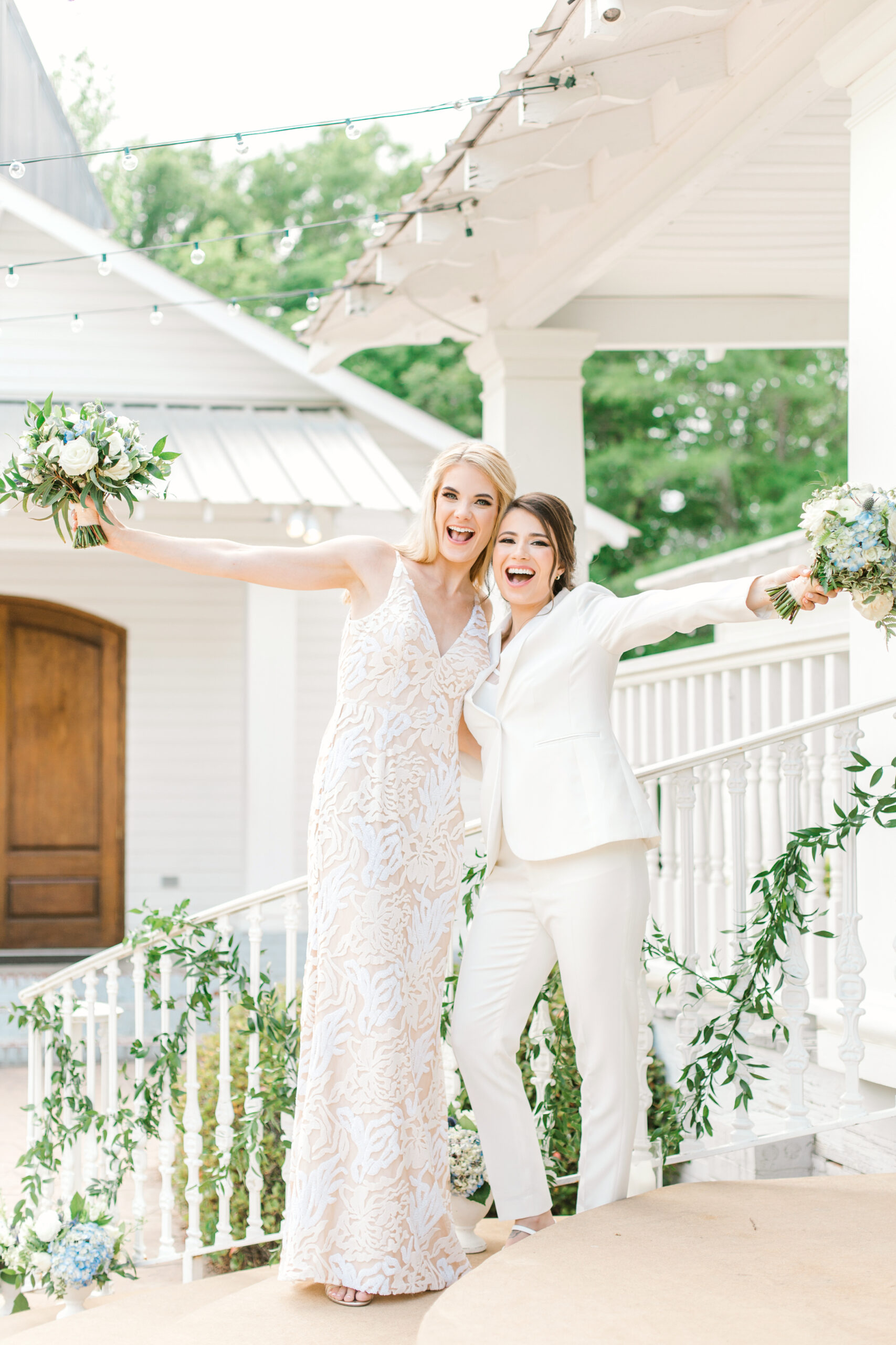 The brides smile together outside The Sonnet House.