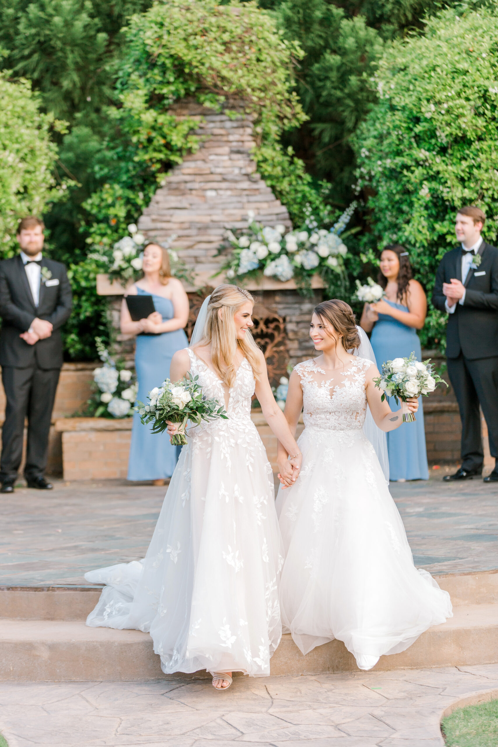 The brides walk together from their wedding ceremony at The Sonnet House in Alabama.