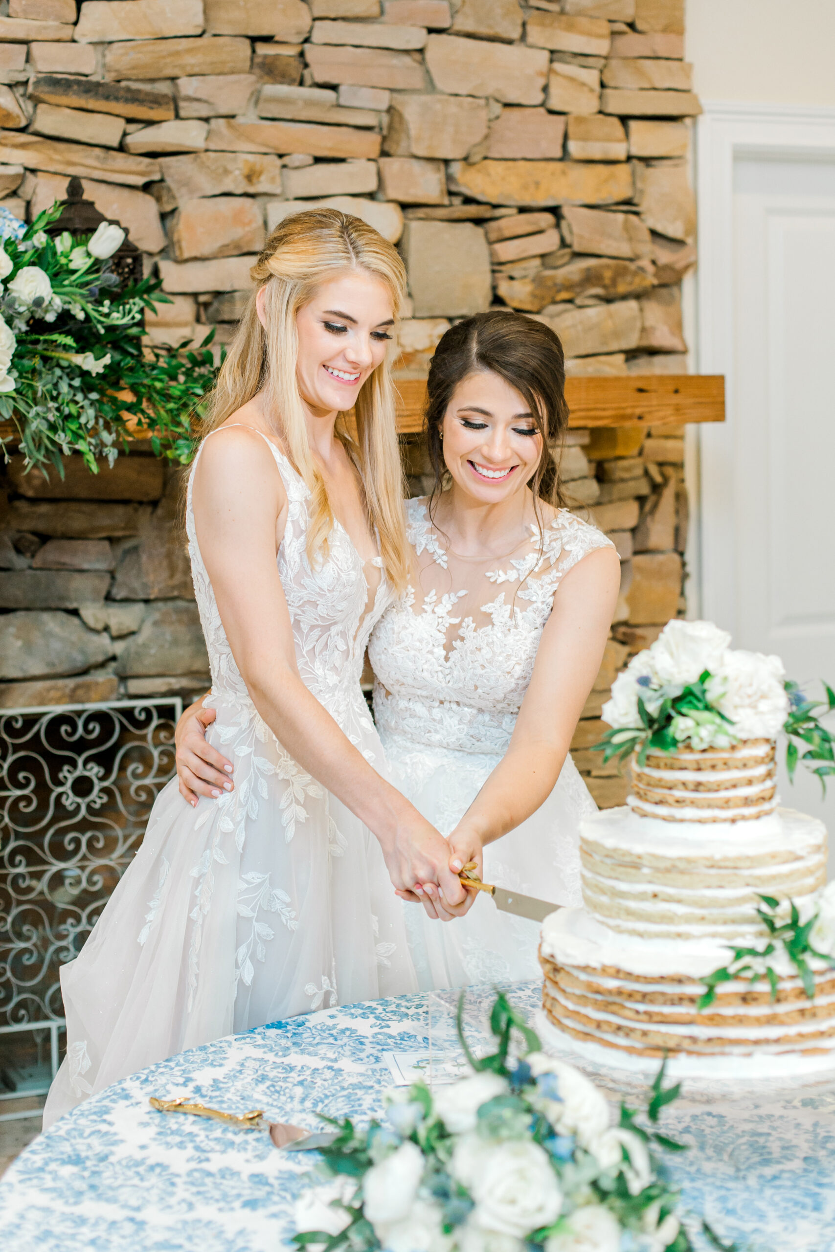 The brides cut the cake at their Southern wedding reception.