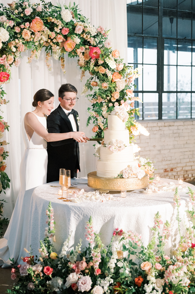 The couple cuts the cake by Olexa's Cafe at their Southern wedding ceremony.