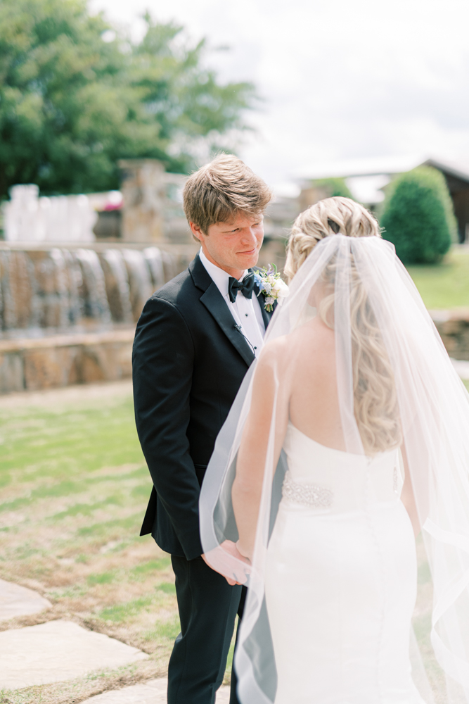 The bride and groom hold hands before their Southern wedding ceremony in Alabama.