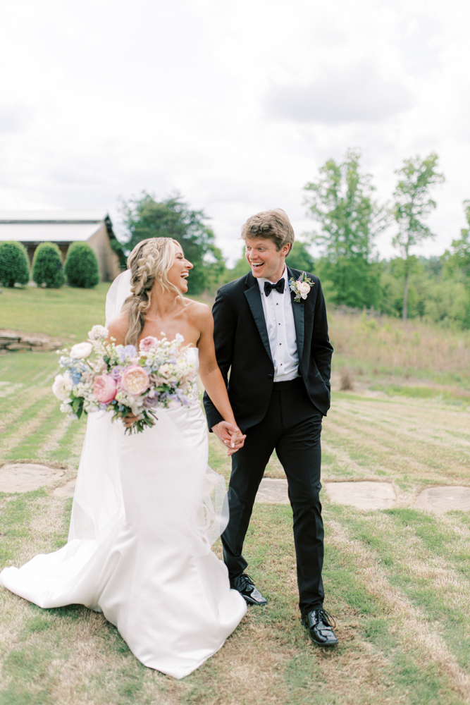 The bride and groom smile together as they prepare for their Southern wedding ceremony at Otter Creek Farmstead.