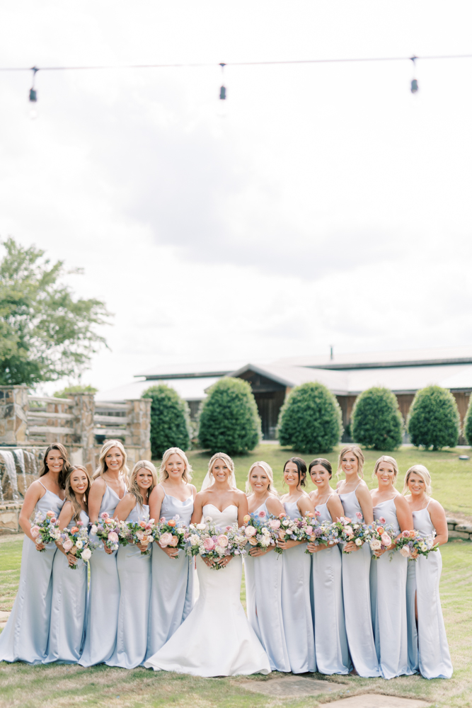 The bridesmaids stand with the bride before the spring wedding ceremony in Alabama.