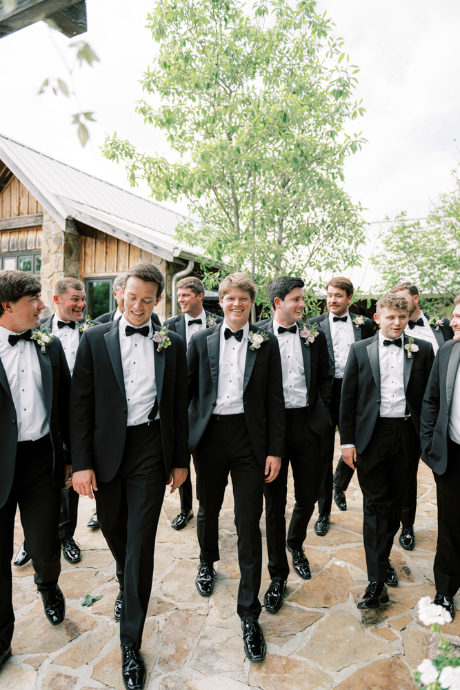 The groomsmen walk with the groom before the wedding ceremony at Otter Creek Farmstead.