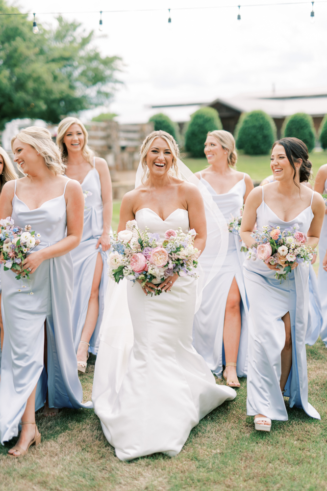 The bridesmaids walk with the bride for the spring wedding at Otter Creek Farmstead.