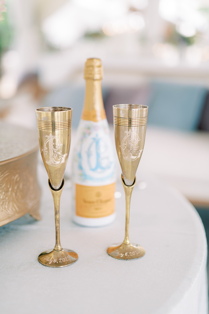 Custom champagne flutes are engraved for the Southern wedding reception at Otter Creek Farmstead.